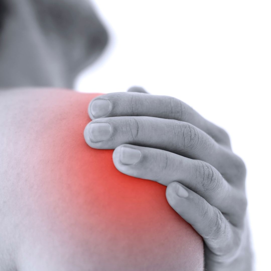 Person holding their shoulder, showing where shoulder bursitis pain is felt