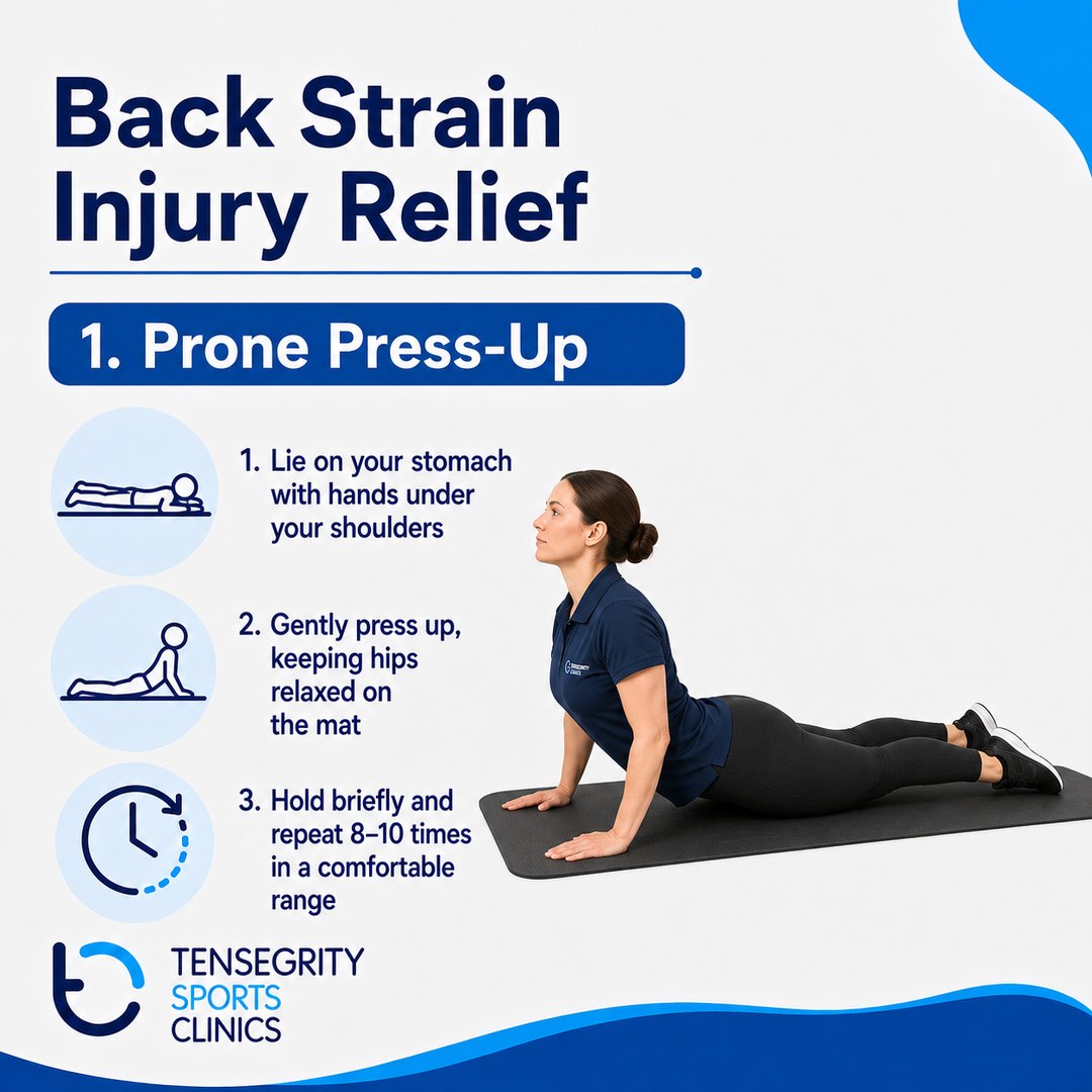 Prone press-up exercise for back strain, lying face down with hands under the shoulders and gently pressing up while the hips stay relaxed