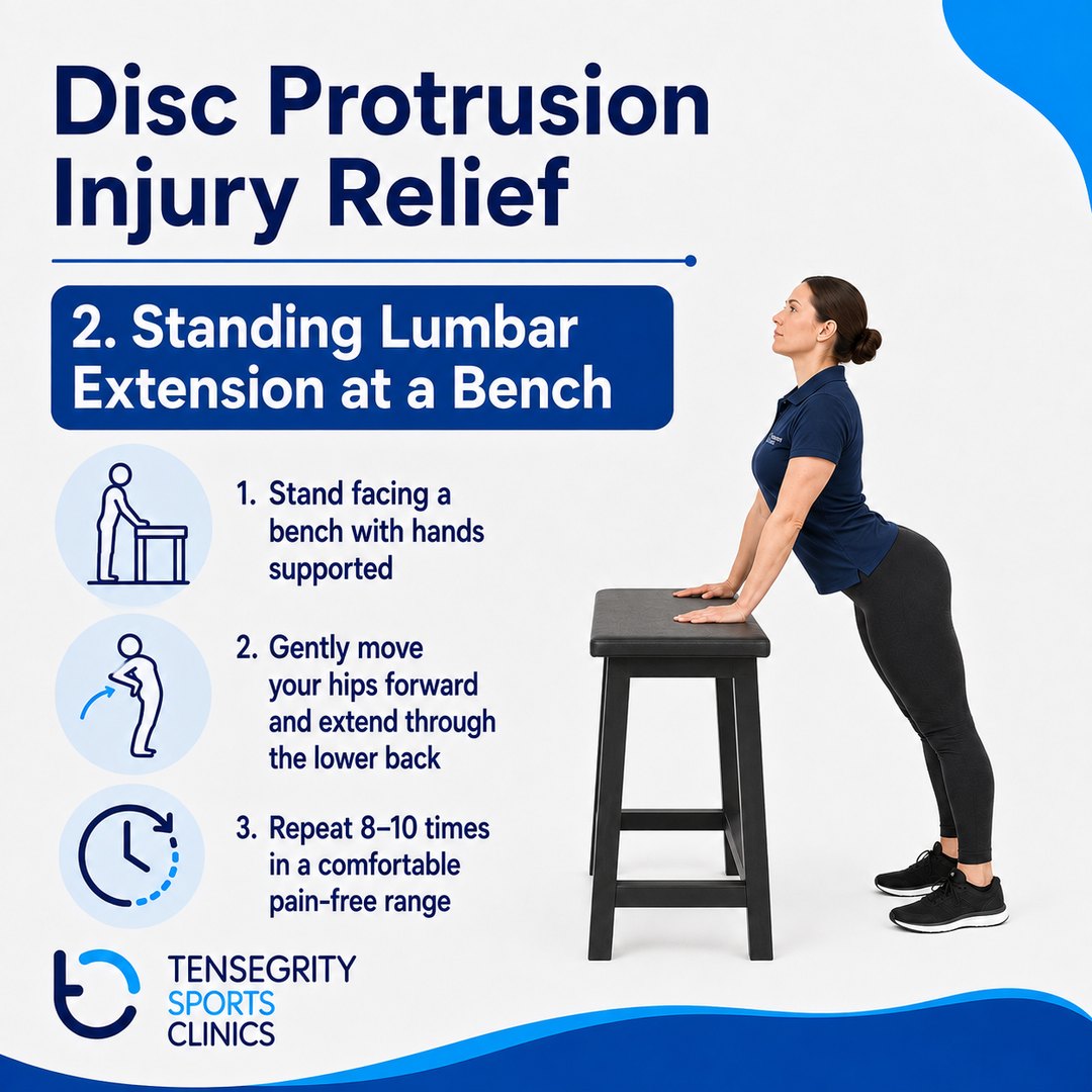 Standing lumbar extension at a bench for disc protrusion, hands supported on a bench while the hips move forward