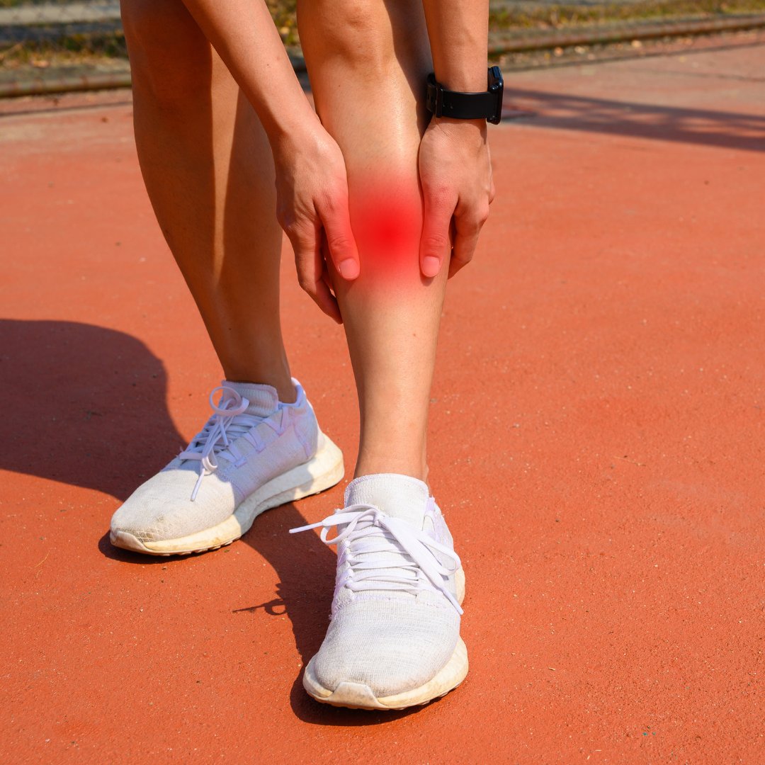 Runner holding the inner border of the shin with pain highlighted, a typical shin splints presentation